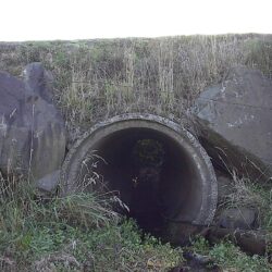 small concrete culvert as shown under a road