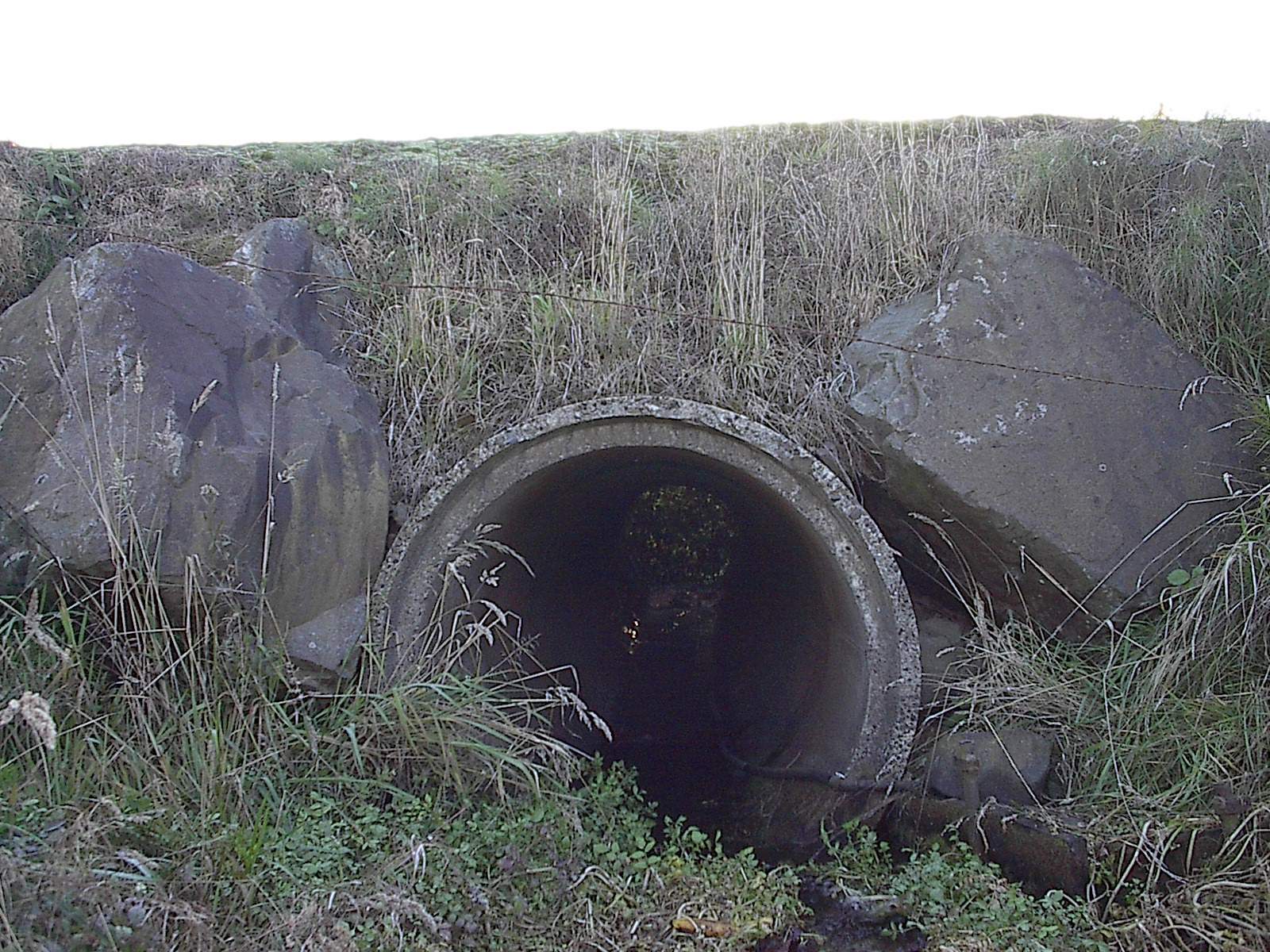 small concrete culvert as shown under a road