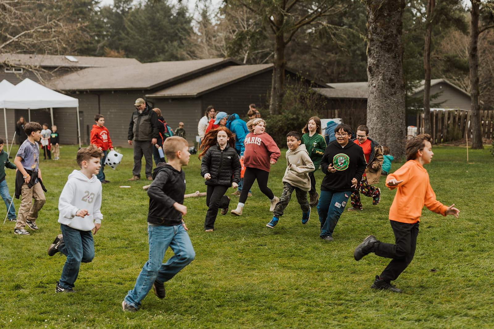children run around outside in the grass