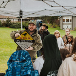 volunteer in state parks green uniform teaching group of students